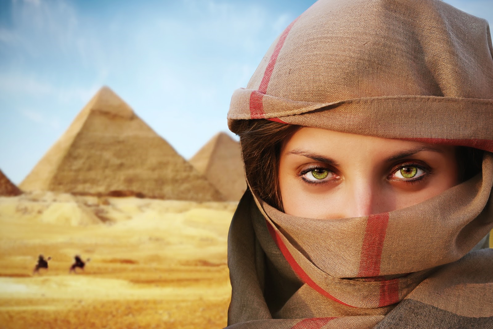 Beautiful green-eyed woman in chador and the pyramids.